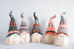 four knitted gnome's hats lined up in a row