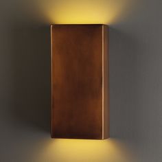 a wall light that is on the side of a wall with a brown box in front of it