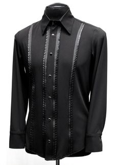 A classic cut, formal shirt for any occasion. A comfortable black rayon shirt with an elegant, tapered fit. Pleated black ribbon trim down the front adds a subtle, understated flair. Fastens in front and at cuffs with rich black pearl snaps. Smoooth! Comes in sizes Small-3X. Measurements: Small: Chest 38-42" Waist 30-32" Medium: Chest 42-44" Waist 32-38" Large: Chest 44-46" Waist 38-42" XL: Chest 48-50" Waist 42-44" XXL: Chest 50-52"" Waist 44-49" 3X: Chest 54' Waist 49" Black Fitted Sleek Shirt, Black Fitted Formal Shirt, Black Long Sleeve Dress Shirt For Party, Tailored Black Top For Evening, Black Fitted Shirt For Semi-formal Occasions, Classic Black Formal Tops, Sleek Black Semi-formal Tops, Classic Fitted Black Shirt, Tailored Black Shirt For Business