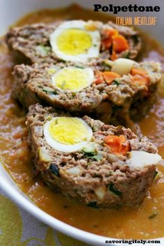 meatloaf with boiled eggs and carrots in a white bowl on top of a table