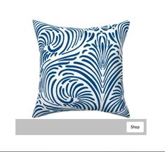 a blue and white pillow sitting on top of a table