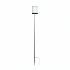 a black floor lamp with a white shade on it's top and bottom corner