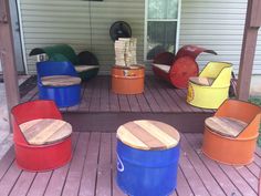 several different colored chairs and stools on the back deck of a house with wood flooring