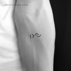 a person with a tattoo on their arm and the letter y is written in black ink