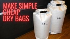 two white bags sitting on top of a wooden floor next to a neon sign that says make simple cheap dry bags