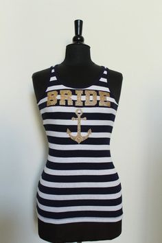 a black and white striped dress with an anchor on the chest, gold sequins