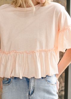 The Taytum Ruffle Sleeve Peplum Top is feminine and modest top that pairs perfectly with denim. Crafted from 100% cotton in a sunwashed peach hue perfect for this season. It has a feminine peplum silhouette with ruffle sleeves, and a modest crewneck. Just add denim and sneakers for a pretty everyday outfit. Style: Peplum, Short Sleeve Color: Peach SIZING TIPS Fit | Loose Fit Stretch | None Our Model wore True to Size. Soft-washed Tops For Spring And Summer, Cotton Tops With Ruffle Hem For Summer, Soft-washed Tops For Spring Day Out, Spring Cotton Tops For Brunch, Cotton Top With Ruffle Hem For Day Out, Cotton Tops With Ruffle Hem For Day Out, Casual Ruffle Hem Top For Brunch, Peach Ruffled Tops For Spring, Casual Light Wash Top With Ruffles