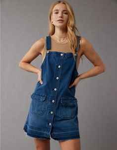 Medium Wash Cotton Denim Jumpsuit With Button Closure, Spring Button-up Overalls With Button Closure, Fall Cotton Denim Jumpsuit, Denim Blue Cotton Dress With Adjustable Straps, Utility Cotton Denim Jumpsuit With Button Closure, Cotton Utility Denim Jumpsuit With Button Closure, Utility Cotton Overalls With Buttons, Cotton Denim Button-up Jumpsuit, Button-up Cotton Denim Jumpsuit