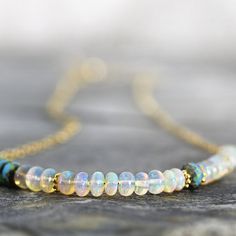 This handmade Ethiopian opal necklace simply glows and will bring your outfits to life with it's fabulous opalescence. Featuring exquisite Ethiopian 'Welo' opals set alongside gorgeous aqua glass beads in a modern, asymmetric design. These opals are the finest quality, flawless, AAA with superb inner fire - they catch the light with every movement and the rainbow of colours is quite mesmerizing. These amazing opals are much larger and plumper than most other opals you'll find. This necklace simp Elegant Wedding Jewelry, Jewelry For Wedding, October Birthstone Necklace, Ethiopian Opal Necklace, Aqua Glass, Opal Bracelet, Bridesmaid Necklace, Wedding Jewellery, October Birthstone