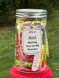 there is a jar that has some candy in it on top of a fire hydrant