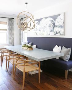 a dining room table with chairs and a bench