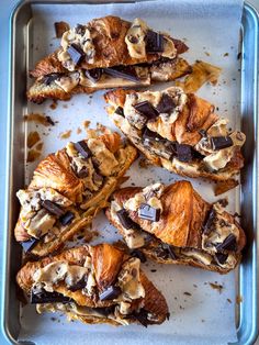 several croissants with chocolate and peanut butter on them in a baking pan