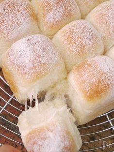 powdered sugar rolls on a cooling rack