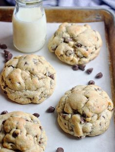 chocolate chip cookies and milk on a baking sheet