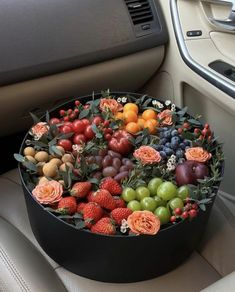 a bunch of fruit is sitting in the back seat of a car with flowers on it