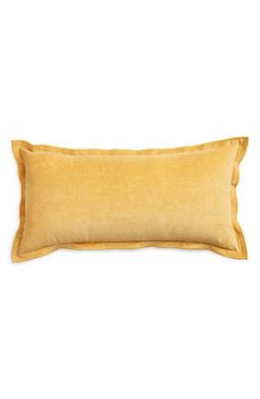 a yellow pillow on a white background