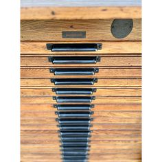 a close up of a wooden drawer with metal handles