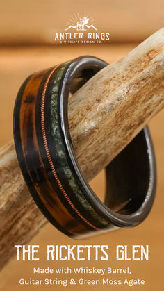 an image of a ring made with whiskey barrel wood and green moss agate inlay