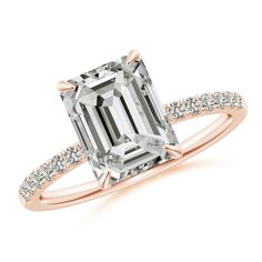 an emerald cut diamond ring with pave set shoulders