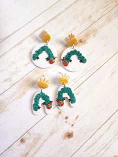 These Hungry Caterpillar earrings are the perfect gift for any teacher or book lover and make the cutest statement earrings!  Choose from circle or arch. Buy the matching keychain under Keychain section in our shop! Handmade with a bit Of Hope and Clay, these earrings are perfectly imperfect, as each pair of earrings is uniquely made.  Message me about custom and/or bulk orders!  *All metal findings and posts on earrings are made from nickel free stainless steel or plated brass. *Even though "nickel free" jewelry is labeled hypoallergenic I cannot promise 100% hypoallergenic materials due people having different levels of sensitivity to different materials. *Colors of actual product may differ slightly from listing pictures. I do my best to capture the actual color of the product in the li Book Clay Earrings, Hungry Caterpillar Earrings, Caterpillar Earrings, Matching Keychain, Teacher Earrings, Book Earrings, Matching Keychains, Nickel Free Jewelry, Hungry Caterpillar