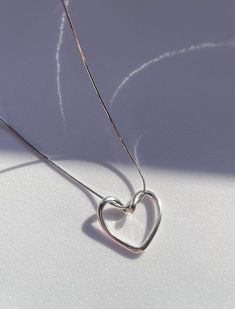 925 Sterling Silver Gold Plating,  Love Bound Heart necklace, love necklace, couple necklace, loop necklace with heart shaped The silver accents on the pendant add a subtle contrast and enhance the overall aesthetic appeal. The dainty design of the necklace makes it versatile, suitable for both casual and formal occasions. It's an exquisite piece that can be worn alone or layered with other necklaces for a personalized look. This necklace also makes a thoughtful Birthday gift for a special person in your life. It's a timeless piece of jewelry that will be treasured for years to come. Features: * Material: 925 Sterling Silver Gold and Rhodium Plating * Lenth: 50 cm / 19,6 inch * Shape: Heart * Comes in Special Gift Box - Kindly provide your telephone number at checkout for delivery purposes Silver Heart Necklace Clavicle Chain For Anniversary, Silver Heart Necklace With Clavicle Chain For Anniversary, Minimalist Heart Pendant Necklace For Anniversary, Simple Heart Pendant Jewelry For Anniversary, Simple Heart Pendant Necklace For Anniversary, Simple Necklaces For Anniversary And Valentine's Day, Silver Minimalist Heart Necklace With Clavicle Chain, Minimalist Sterling Silver Heart Necklace With Clavicle Chain, Sterling Silver Minimalist Heart Necklace With Clavicle Chain