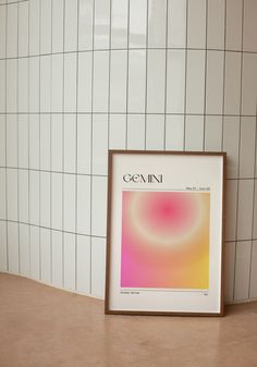 a white tiled wall next to a framed poster