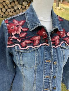 Beautiful women's size small petite denim jacket embellished with pink and maroon flowers embroidered on black tulle on front and back yokes. Jacket measures 19" across the chest when buttoned. This jacket would make such a beautiful, unique gift for the woman who loves one-of-a-kind items in her wardrobe!  Spot clean only!! Fitted Floral Print Denim Jacket, Fitted Pink Denim Jacket For Spring, Fitted Denim Jacket With Floral Embroidery For Summer, Embellished Cotton Denim Jacket, Fitted Casual Denim Jacket With Floral Print, Fall Embellished Cotton Denim Jacket, Casual Fitted Denim Jacket With Floral Print, Fitted Red Denim Jacket With Long Sleeves, Fitted Denim Outerwear With Floral Embroidery