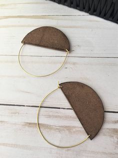 A lot of love and attention to detail went into these brown circle leather statement earrings. Leather pieces were cut into the half moon shape. Each moon was then given a tiny touch of gold paint on the bottom. The edges of the crescents were then burned to give them a darkened, rustic appearance. The ear wires were cut to length and formed into the curved shape. The ear wires are made from jeweler's bronze. These earrings measure approximately 2 5/16 x 3 inches. Thanks for checking out my earr Brown Hoop Earrings With Ear Wire For Gift, Brown Single Hoop Earring As Gift, Handmade Brown Hoop Earrings For Everyday Wear, Brown Small Hoop Earrings As Gift, Everyday Handmade Brown Hoop Earrings, Brown Leather Minimalist Earrings, Minimalist Brown Leather Earrings, Modern Brown Leather Earrings, Brown Hoop Earrings Gift