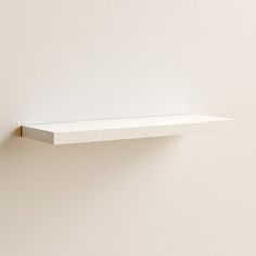 an empty white shelf on the wall with no one in it or someone else is there