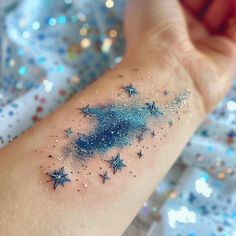 a person's arm with stars on it