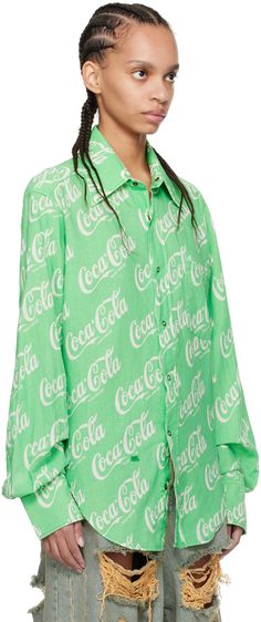 Linen- and cotton-blend hopsack shirt. Logo graphic pattern printed throughout. · Pointed collar · Press-stud closure · Patch pocket · Logo embroidered at front · Shirttail hem · Two-press-stud barrel cuffs · Inverted box pleat at back yoke Part of the ERL Coca-Cola® capsule collection. Supplier color: Green Trendy Cotton Shirt With All Over Print, Cotton Graphic Print Button-up Shirt, Green Graphic Print Shirt For Work, Cotton Graphic Print Blouse With Relaxed Fit, Relaxed Fit Cotton Blouse With Graphic Print, Cotton Blouse With Graphic Print And Relaxed Fit, Green Collared Shirt With All Over Print, Cotton Button-up Blouse With Graphic Print, Graphic Print Spread Collar Top For Spring