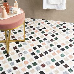 a bath room with a toilet and a tiled floor