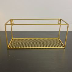 a yellow metal shelf sitting on top of a wooden floor