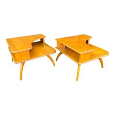 two wooden tables sitting next to each other on top of a white surface with no one in it