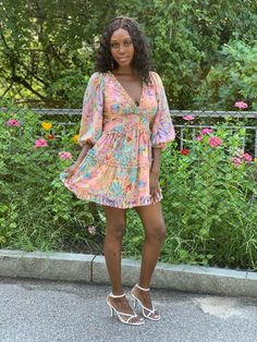 This Floral is dress is a summer must have. Take your style up a notch with this flawless floral open back dress. This dress is fully lined in a mini length featuring a plunging neckline, back neck button closure, and invisible back zipper. This flirty mini dress is perfect for any summer occasion. Dress it up with a statement heel or keep it casual with a summer sandal. Model is wearing a size small Fits true to size for most 100% Polyester Dress Length: 31 inches Feminine Floral Print V-neck Mini Dress, Floral Print V-neck Dress For Summer Brunch, Feminine V-neck Mini Dress For Vacation, Floral Print Sundress V-neck For Day Out, Lined Mini Dress For Garden Party, Multicolor Floral Print V-neck Dress For The Beach, Flowy Floral Print Mini Dress, Spring Floral Print V-neck Dress For Vacation, Flirty Mini Dress For Summer Garden Party