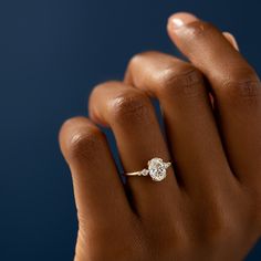 a woman's hand with a diamond ring on it