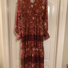 Floral Tiered Midi Dress With Ties In Back. Size Medium Nwt Color Rust Long Floral Print Patterned Dress, Patterned Vacation Dresses For Fall, Patterned Fall Vacation Dress, Boho Print Patterned Dress For Brunch, Patterned Boho Print Dress For Brunch, Patterned Beach Dresses For Fall, Patterned Beach Dress For Fall, Fall Beach Dresses In Patterned Style, Long Brown Dress With Floral Print