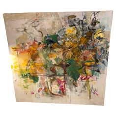 an abstract painting with lots of different colors and shapes on it's surface, including flowers