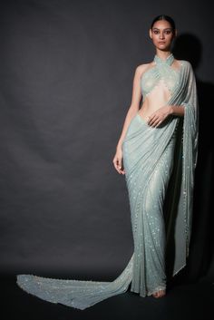 Editor's Note Featuring a pre-draped sari in refreshing shade of mint green paired with halter blouse Fabric: Net Color: Mint green Neckline: Halter Sleeve type: Sleeveless Component: Sari and blouse Occasion: Cocktail and reception Care: Dry Clean Only About the Designer Itrh makes a high-end luxury Indian ethnic wear made using exquisite and endangered age-old crafts such as kalamkari, madhubani, chikankari, zardozi, and gota weaving. The focus of the house is to cherish the beauty of handcraf Farewell Saree, Saree Backless, Extra Outfits, Halter Blouse, Eternal Beauty, Simple Sarees, Indian Fashion Saree, Saree Designs Party Wear, Drape Saree