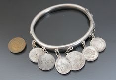 "1890's, Austria-Hungary. Love tokens hinged bangle bracelet. MADE OF: silver 750 - 835, stone tested. CONDITION: Very good antique condition. Few micro dents. Ages patina. Push button box closure works fine. MEASUREMENTS: Inner circumference: 7 1/16\" (18cm). Width on back: 3/16\" (5mm). Weight: 19,8g. * * * All our items are packed in gift boxes, easy to check of content and re-pack. If you wish something special, please let us know. * * * LAYAWAYS: All items can be put on layaway, max 4 month Crystal Locket, Austria Hungary, Christmas Bling, Austro Hungarian, Glass Locket, Love Token, Photo Pendant, Hinged Bracelet, Puffy Heart