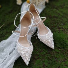 the bride's wedding shoes are sitting on the ground