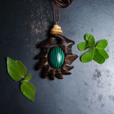 This Pendant is a handmade piece that was carved by hand. It matched very nicely with this beautiful Malachite Gemstone! -Finished with camellia oil. -The cord length is adjustable so it may hang low on the chest or high around the neck, however you prefer. Every wooden part is selected and carefully stored until it is cured into a stabilized condition to preserve it in a mint-like state. Each piece is found through a journey of admiration and respect to the ancient process, led by nature. -All items are unique and made by me. -If you have any questions, feel free to drop me a message! Oval Spiritual Carved Necklaces, Unique Green Carved Necklace, Artisan Carved Pendant Jewelry, Artisan Malachite Gemstone Jewelry, Spiritual Carved Oval Jewelry, Spiritual Style Carved Oval Jewelry, Artisan Jewelry With Natural Malachite Stones, Artisan Malachite Jewelry Gift, Artisan Malachite Jewelry With Natural Stones