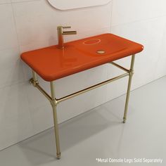 an orange sink in a white bathroom with a mirror on the wall and tile floor