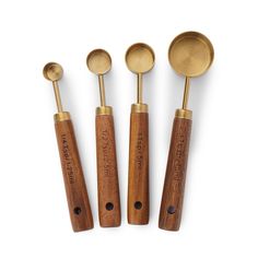 three wooden spoons and two metal measuring spoons