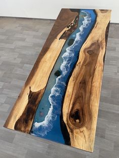 a piece of wood that is on the ground with water running down it's side