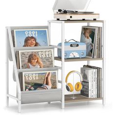 a white shelf with pictures, headphones and a record player on top of it