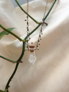 This magical necklace features a cute little glass vial with a modified cork top as its center piece. It is filled with itty bitty natural quartz points, and is hand wrapped with 26 gauge oxidized brass wire. The vile hangs from a hypo allergenic antiqued brass chain. The delicate 16 inch chain is lined with micro faceted clear quartz drops, and it can be adjusted to 18 inches long. Be careful with your cork top! This vial is not sealed so that you can play with the little crystals inside This item is handmade made using natural gemstones, so there will be some variation with every new necklace. Vial Necklace, Bottle Jewelry, Oxidized Brass, Glass Vials, Funky Jewelry, Itty Bitty, Rutilated Quartz, Quartz Points, Pink Opal