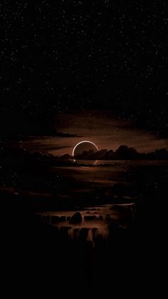 an eclipse in the night sky with stars