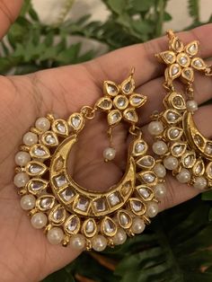 Premium quality gold-plated kundan chandbali earrings with moti (pearls). Very gorgeous pair. Care Instruction: Avoid heat & substances like perfume, deodorant, alcohol, etc and clean with silver/gold polish cloth. Store in airtight spaces like ziplock pouch or jewelry box. Luxury Tilla Chandbali Bridal Earrings, Luxury Festive Kundan Chandbalis, Luxury Gold Plated Bollywood Chandbalis, Cheap Bohemian Chandbali Danglers, Luxury Festive Chandbalis For Party, Luxury 22k Gold Chandbali Kundan Necklace, Luxury Gold Hoop Earrings With Latkans, Luxury Gold-plated Chandbalis For Celebration, Luxury Gold Meenakari Chandbalis