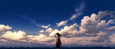 a woman standing in the water with clouds behind her